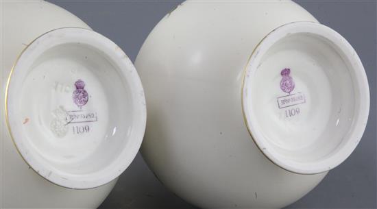 A pair of Royal Worcester ivory ground twin handled vases, date code for 1887, height 23cm